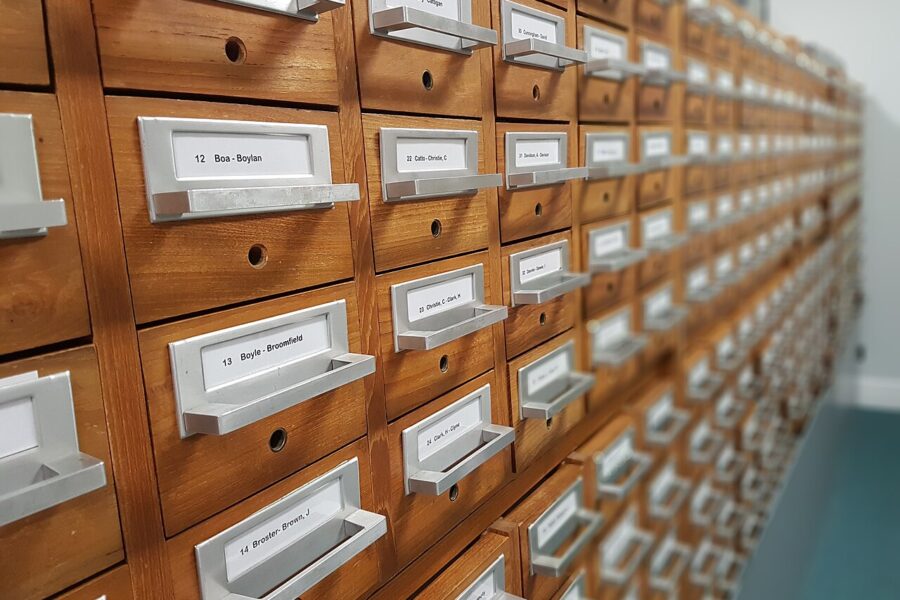 A card filing cabinet: an inventory records what exists, not what it achieved (illustrative).
