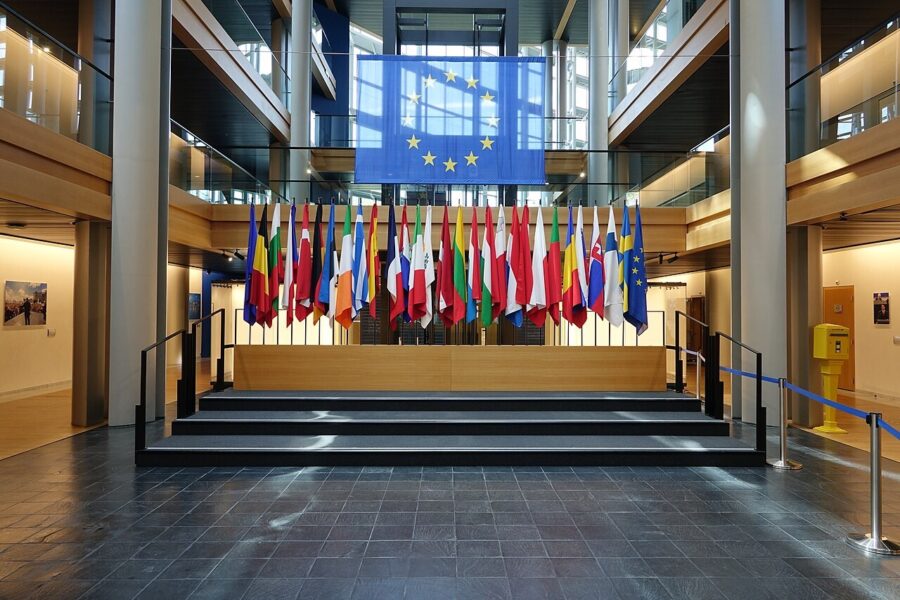A curved, empty interior circulation area inside the European Parliament building in Strasbourg, lit from above.