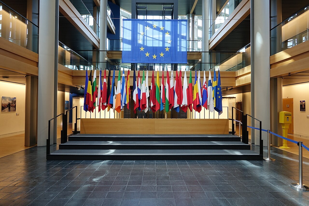A curved, empty interior circulation area inside the European Parliament building in Strasbourg, lit from above.