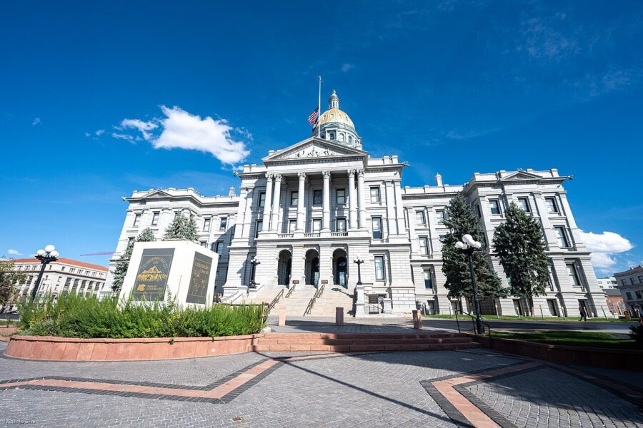 The gold-domed Colorado State Capitol building in Denver under a blue sky