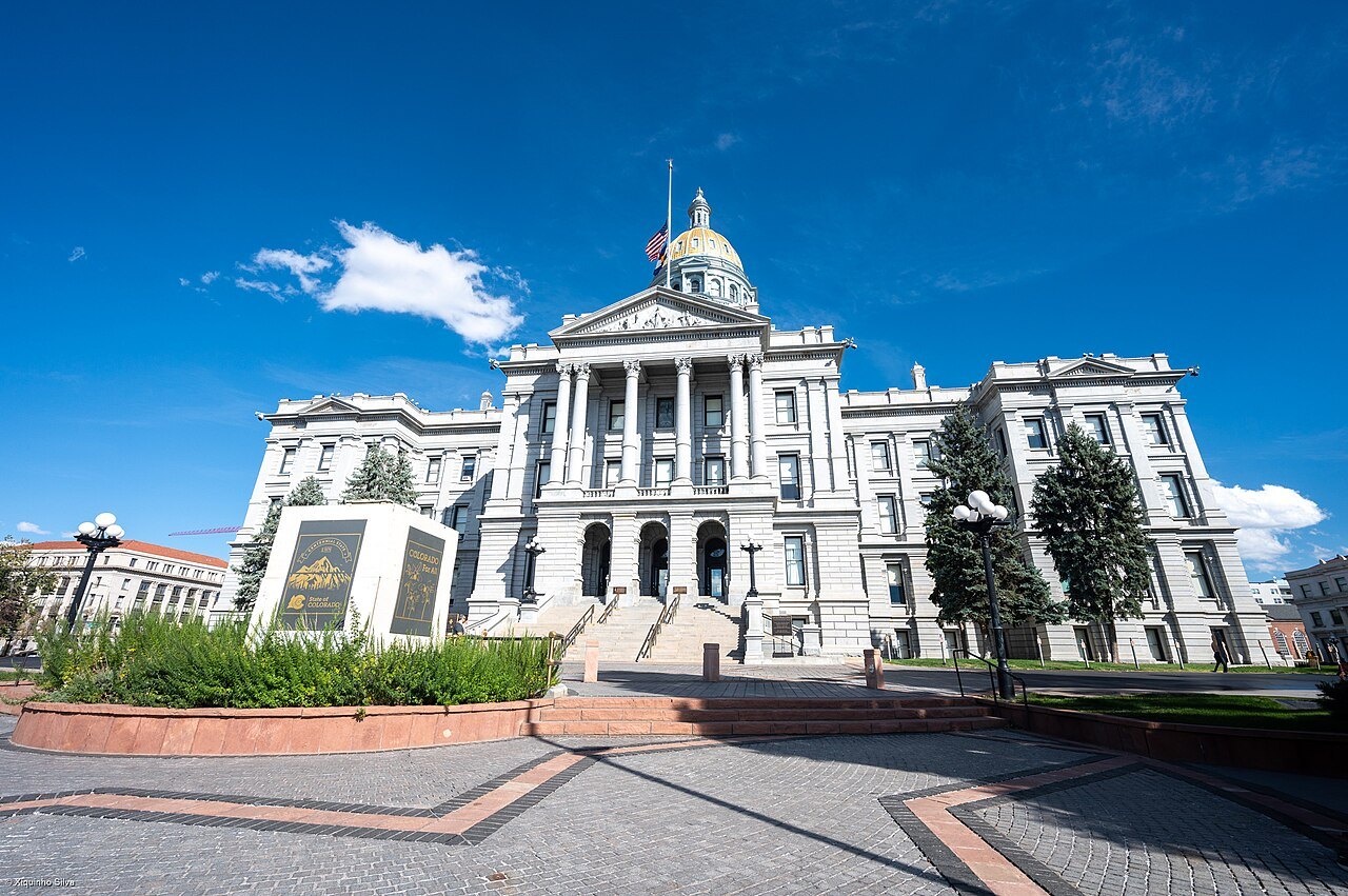 The gold-domed Colorado State Capitol building in Denver under a blue sky