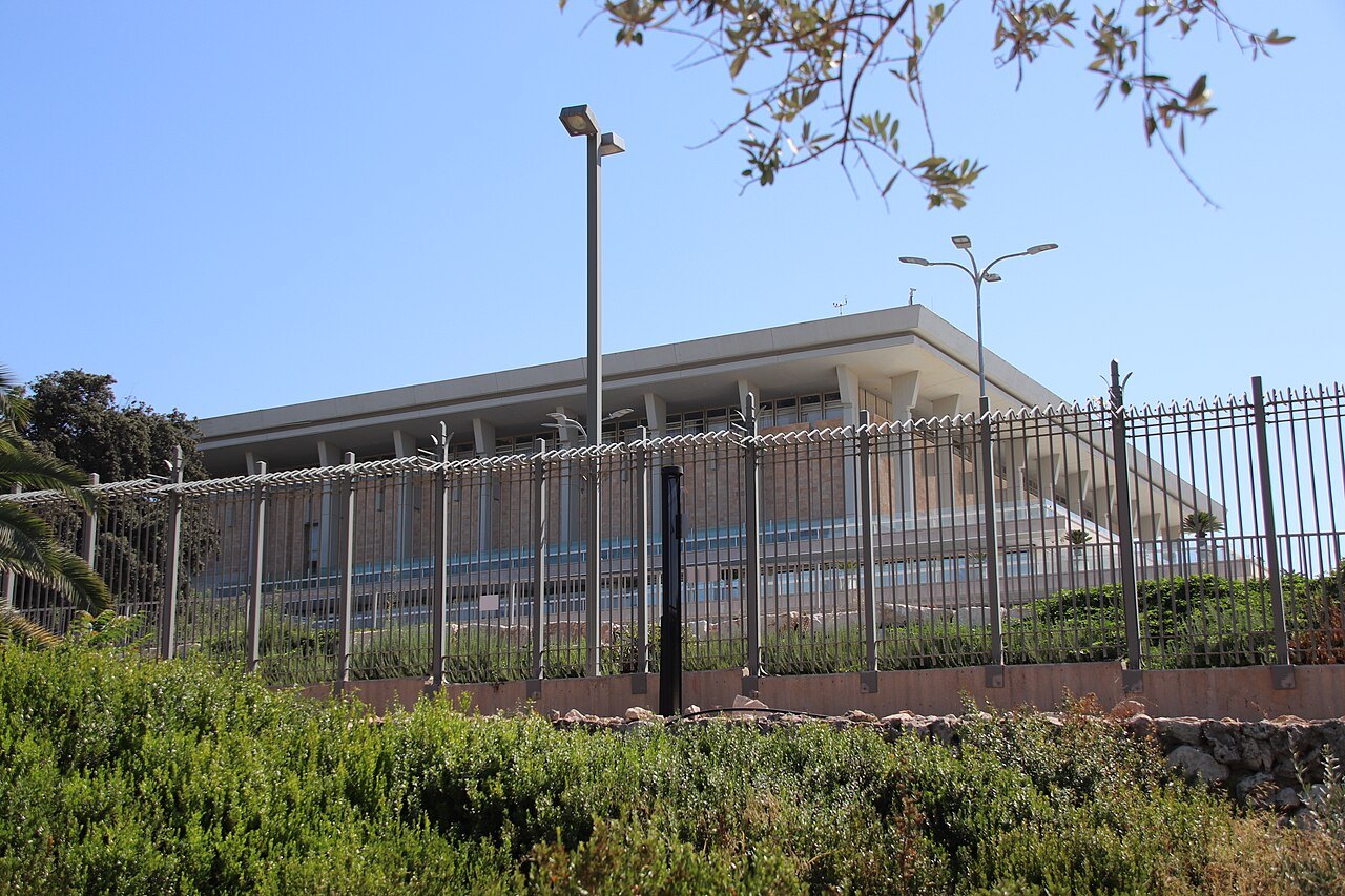 The rectangular colonnaded Knesset building in Jerusalem under a clear sky