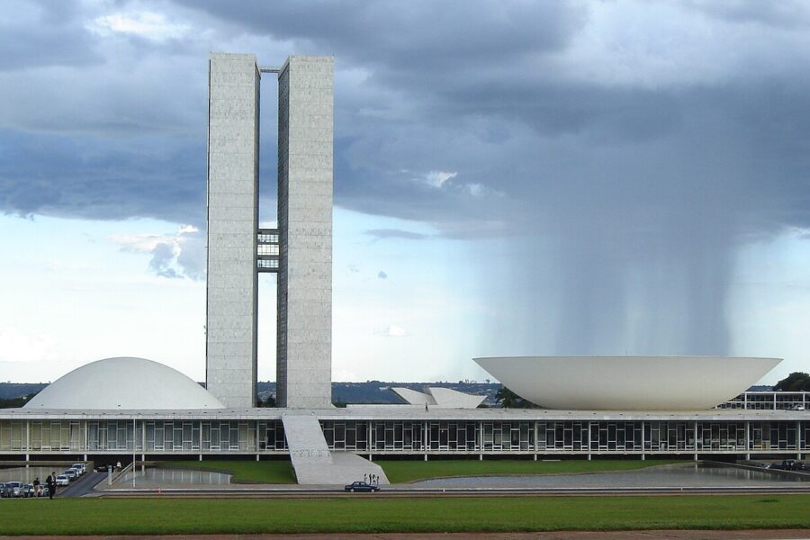 The twin towers and domes of Brazil's National Congress building in Brasília under a rainy sky