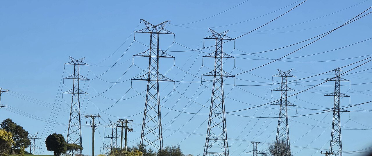High-voltage transmission towers and power lines across open country at Bell Bay, Tasmania
